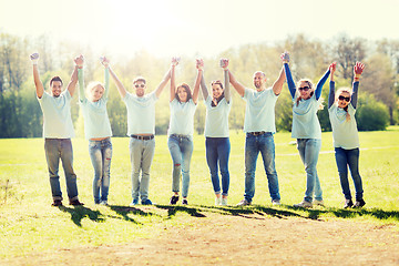 Image showing group of volunteers celebrating success in park