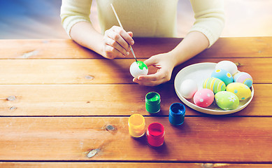 Image showing close up of woman hands coloring easter eggs