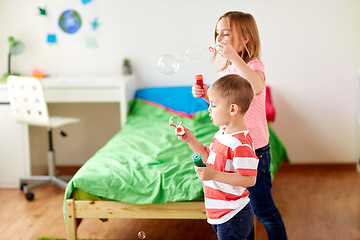 Image showing kids blowing soap bubbles and playing at home