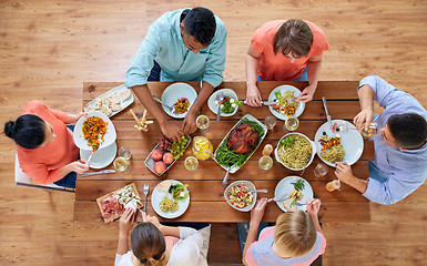 Image showing group of people eating at table with food