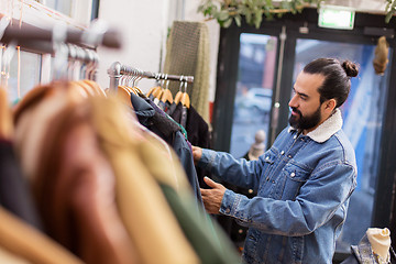 Image showing man choosing clothes at vintage clothing store