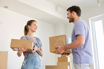 Image showing happy couple with boxes moving to new home