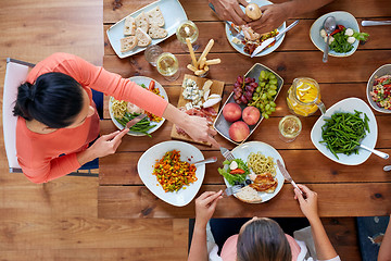 Image showing group of people eating at table with food