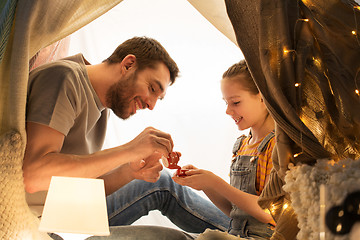 Image showing family playing tea party in kids tent at home