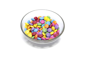 Image showing Bright colorful candy in glass bowl on white background