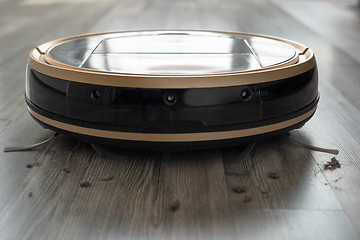 Image showing robotic vacuum cleaner on laminate wood floor