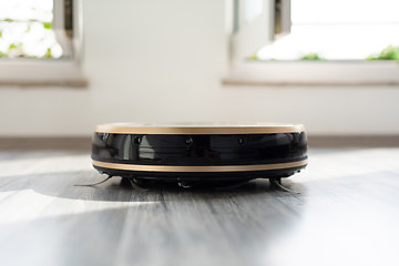 Image showing robotic vacuum cleaner on laminate wood floor