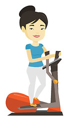 Image showing Woman exercising on elliptical trainer.