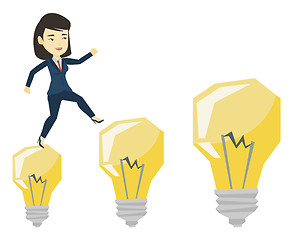 Image showing Business woman jumping on light bulbs.