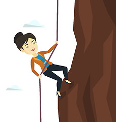 Image showing Business woman climbing on the mountain.