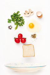 Image showing The falling ingredients of fried egg. Healthy breakfast ingredients.