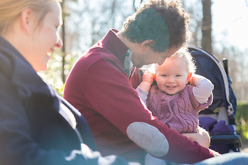 Image showing Young family with cheerful child in the park.