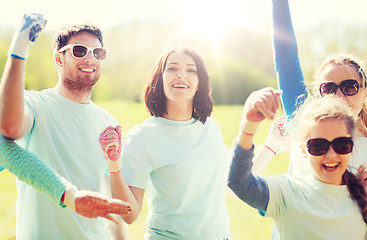 Image showing group of volunteers celebrating success in park