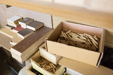 Image showing wood dowel pins and board samples at workshop