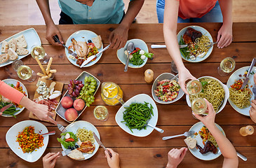 Image showing group of people eating at table with food