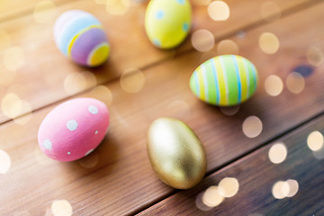 Image showing close up of colored easter eggs on wooden boards