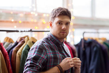 Image showing man choosing clothes at vintage clothing store