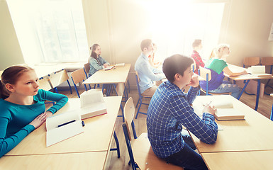 Image showing group of students with books at school lesson