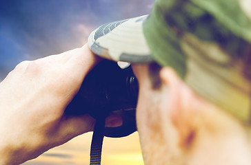 Image showing close up of soldier looking to binocular