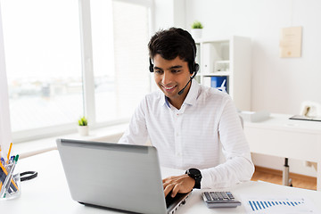 Image showing businessman with headset and laptop at office