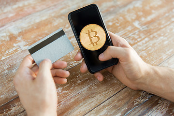 Image showing close up of bitcoin on smartphone and credit card