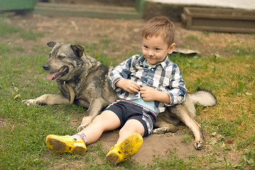 Image showing Boy hugging his dog