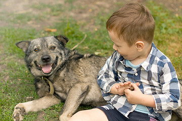 Image showing Boy hugging his dog