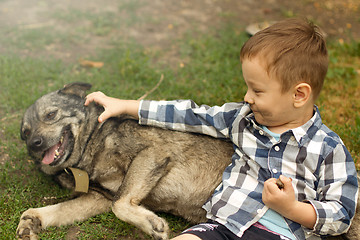 Image showing Boy hugging his dog