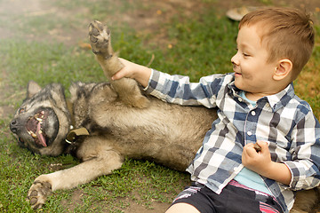 Image showing Boy hugging his dog