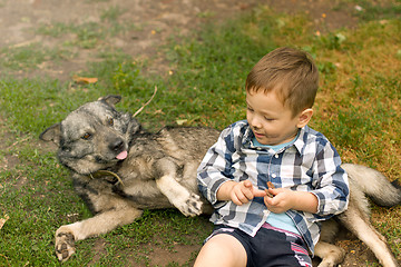 Image showing Boy hugging his dog