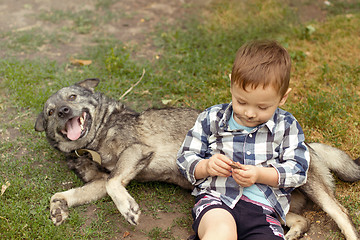 Image showing Boy hugging his dog