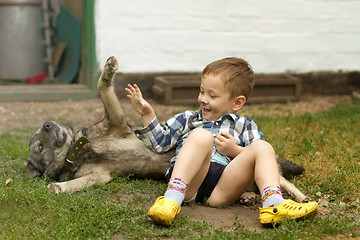 Image showing Boy hugging his dog