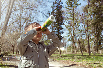 Image showing Boy looking at the kaleidoscope outdoors