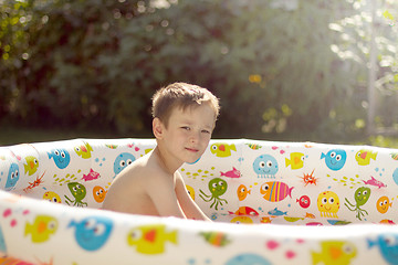 Image showing Boy playing in a swimming pool