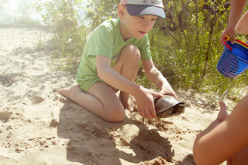 Image showing Happy boy and the turtle on the beach