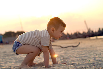 Image showing Happy boy playing on the beach