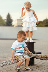 Image showing Happy family brother and sister playing on the embankment