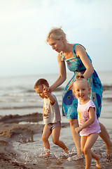 Image showing Happy family playing on the beach