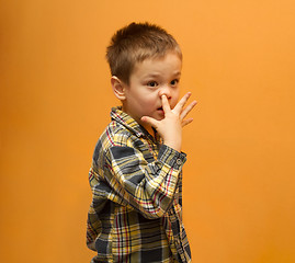 Image showing Little boy picking his nose