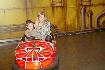 Image showing Mother and son driving autoscooter