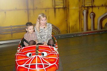 Image showing Mother and son driving autoscooter