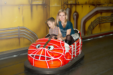 Image showing Mother and son driving autoscooter