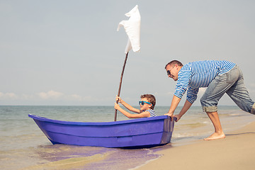 Image showing Father and son  playing on the beach at the day time.