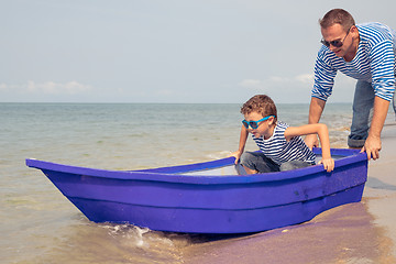 Image showing Father and son  playing on the beach at the day time.