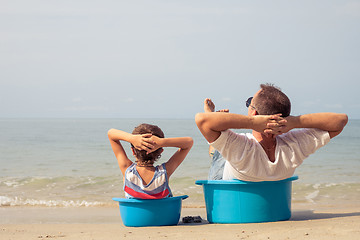 Image showing Father and son  playing on the beach at the day time.