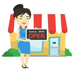 Image showing Female shop owner holding open signboard.
