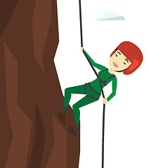 Image showing Woman climbing in mountains with rope.