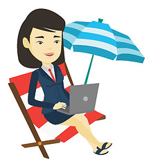 Image showing Business woman working on laptop at the beach.