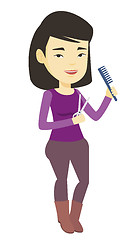Image showing Hairstylist holding comb and scissors in hands.