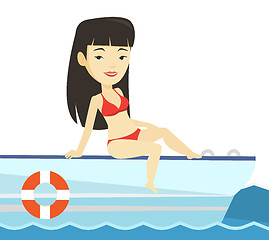 Image showing Young happy woman tanning on sailboat.